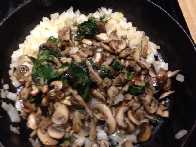 While the bread is toasting, saute (separately) sliced mushrooms and chopped onion. Add everything back into the same pan, and toss in a handful or more of chopped bitter greens like kale or Swiss chard. Remove from heat to cool