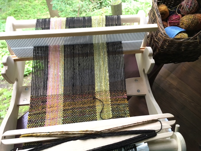 Beautiful silky alpaca from Spinner's End Farm (and some leftover handspun) create the warp. I'm using handspun Hobbledehoy battlings for the weft.
